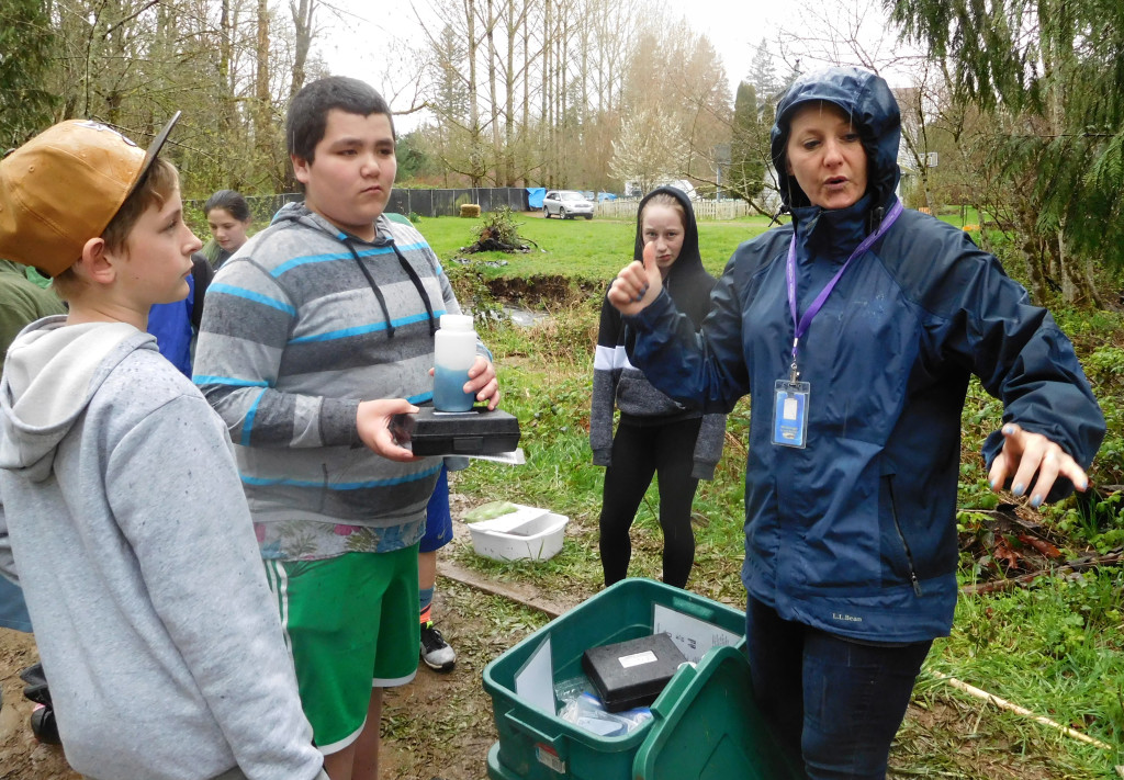 Students listen to instructions from Rainy Rau before starting their research.