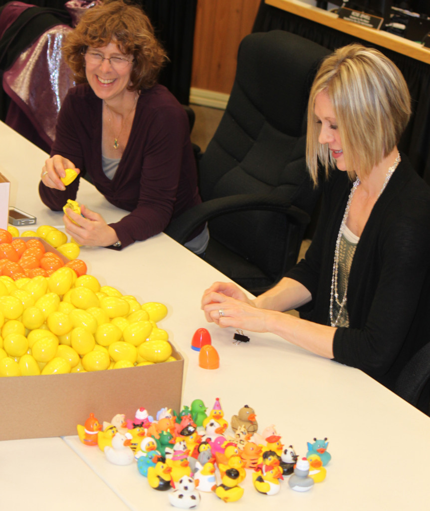 Rene Carroll (left) and Courtney Wilkinson (right) fill plastic eggs with candy in preparation for Wednesday's EGGstravaganza event at Reflection Plaza in downtown Washougal. Wilkinson said the Downtown Washougal Association decided to plan an Easter activity after special events for Halloween and Christmas proved popular with local residents. 
