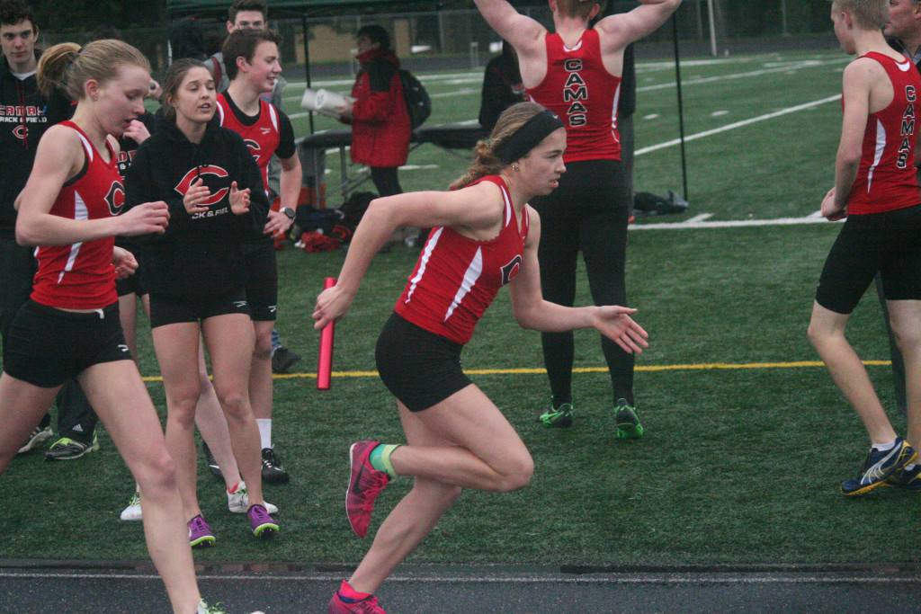 Rachel Blair takes the baton and runs one more lap for the Papermakers. She won the 1,600, 800 and anchored the 1,600 relay squad to victory in her first high school track meet. (Photos by Dan Trujillo/Post-Record)