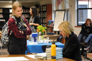 Northwest author and KINK-FM radio personality Sheila Hamilton signs a copy of her book, "All The Things We Never Knew," for a WHS student. Hamilton spoke to students last week at an assembly, then one-on-one in the library. 