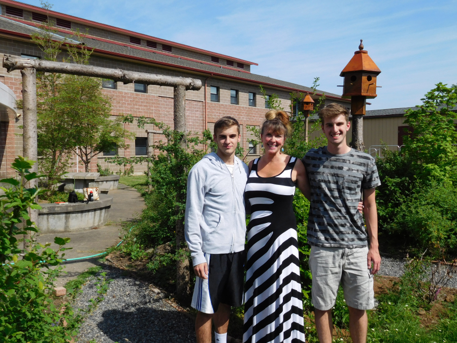 Ryan and Bradshaw stand with Skyridge Middle School teacher Gayle Cooper in the school's garden, where they completed their Eagle Scout projects. Ryan made benches and arbors, while Bradshaw designed and created birdhouses.