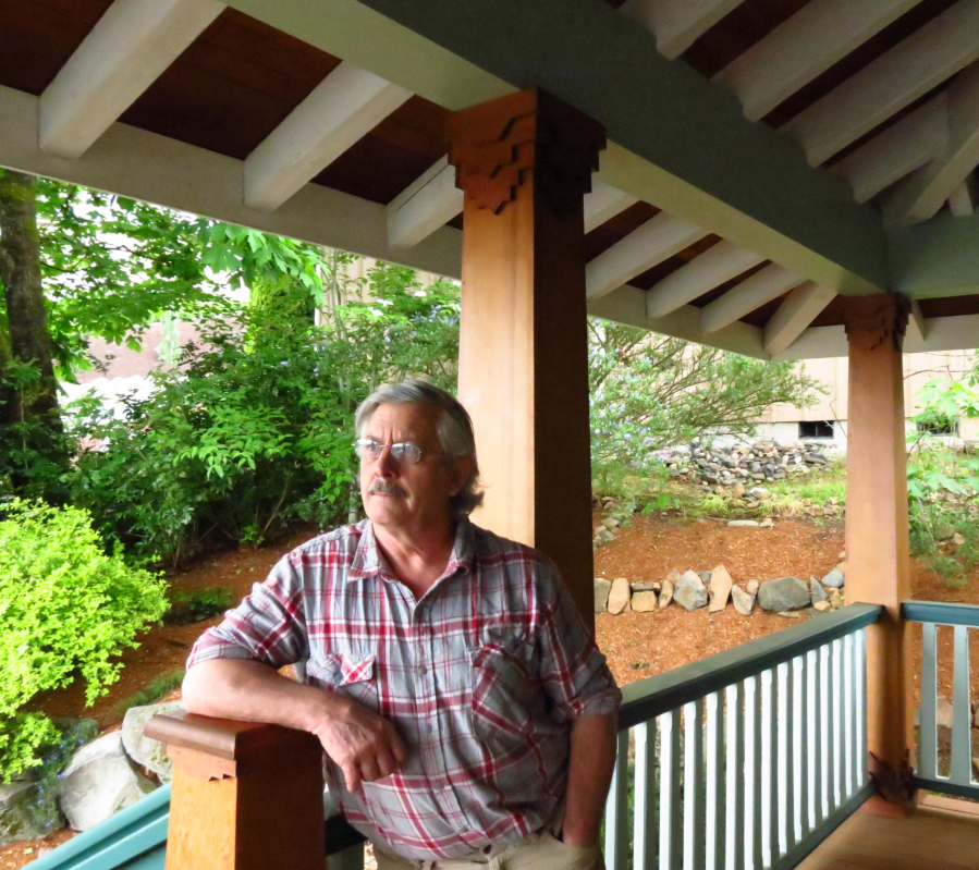 The porch in front of Brian Skinner's home was created using wood from an old log cabin he had salvaged years earlier. Front porches are his "greatest love." 