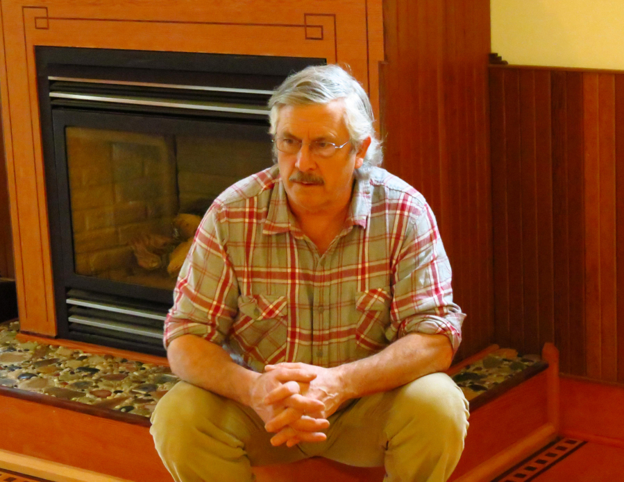 Skinner talks about the unique aspects of his hand-crafted house, which was built using pieces of Douglas fir, cedar, maple and walnut. The stones at the base of the fireplace he collected and polished, then pressed into the concrete by hand.