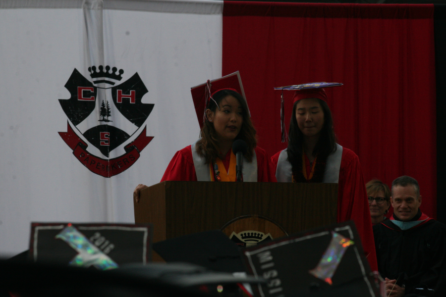 Valedictorian Amanada Shi and salutatorian Connie Wang address their classmates during graduation at Doc Harris Stadium. 