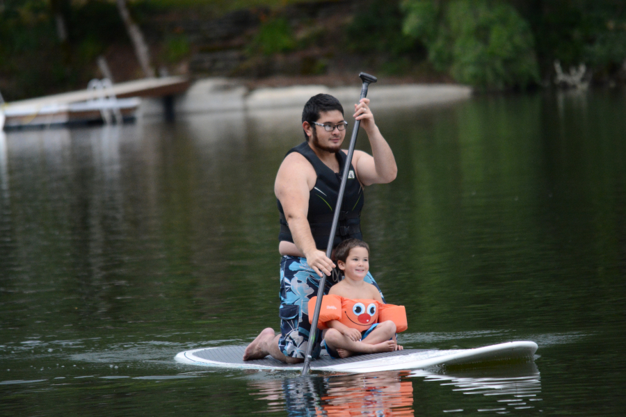 Nick Tomihama and his son, Noah, take a spin on a Sweetwater SUP paddle board Friday, at Lacamas Lake.