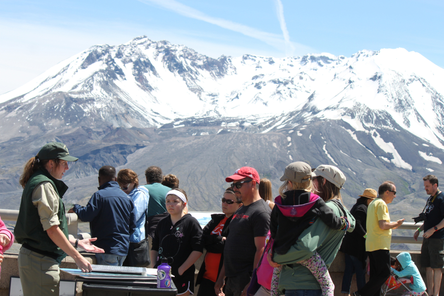 A forest ranger provides information to visitors at the Johnston Ridge Observatory, located five miles from the base of  Mount St. Helens. It hosts interpretive displays that tell the biological, geological, and human stories of the volcano.