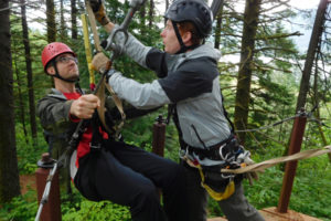A guide locks a first-time zip-liner into place during a Skamania Lodge Zip Line Tour. For $99 per person, two guides will take groups of up to 10 people through seven different lines ranging from 100 to 900 feet in length. 