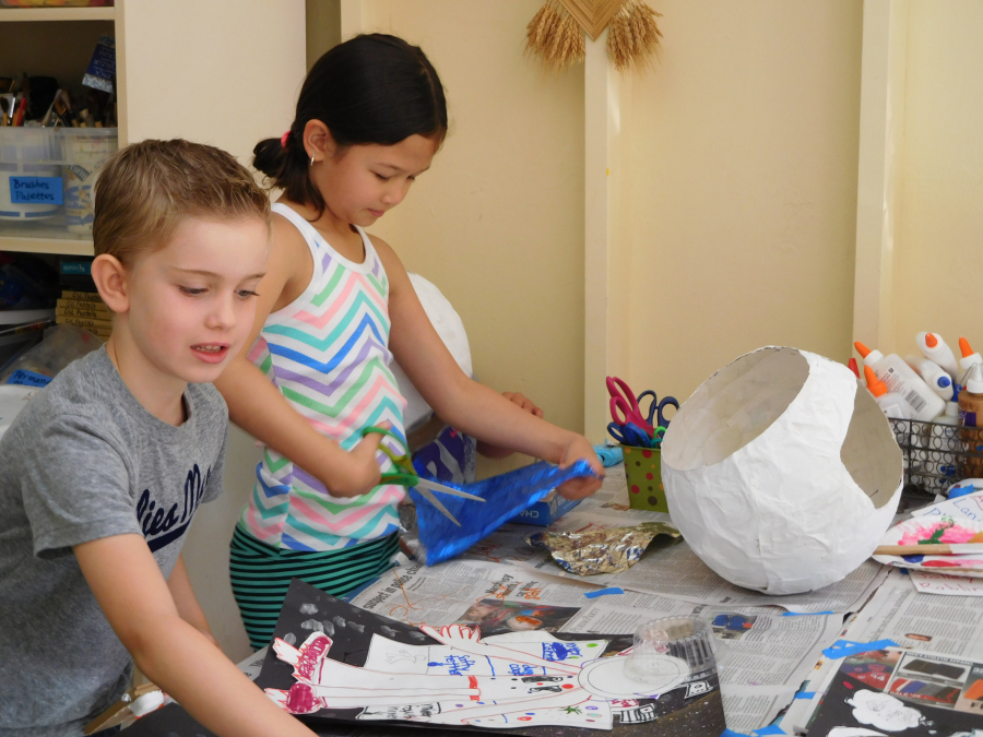 Camp Windy Hill has several offerings during summer and winter break. Here, participants create masks and astronaut self-portraits at the Outer Space Adventures camp.