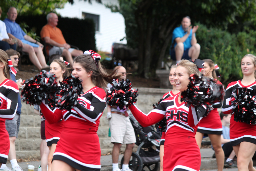 The Camas High School cheerleaders, including Brienne Pfeifer (left) and Emma Ware (right) brought a dose of enthusiasm and excitement to the Grand Parade on Saturday. The Papermakers' appearance, which also included the school's marching band, has become a highlight of the event.