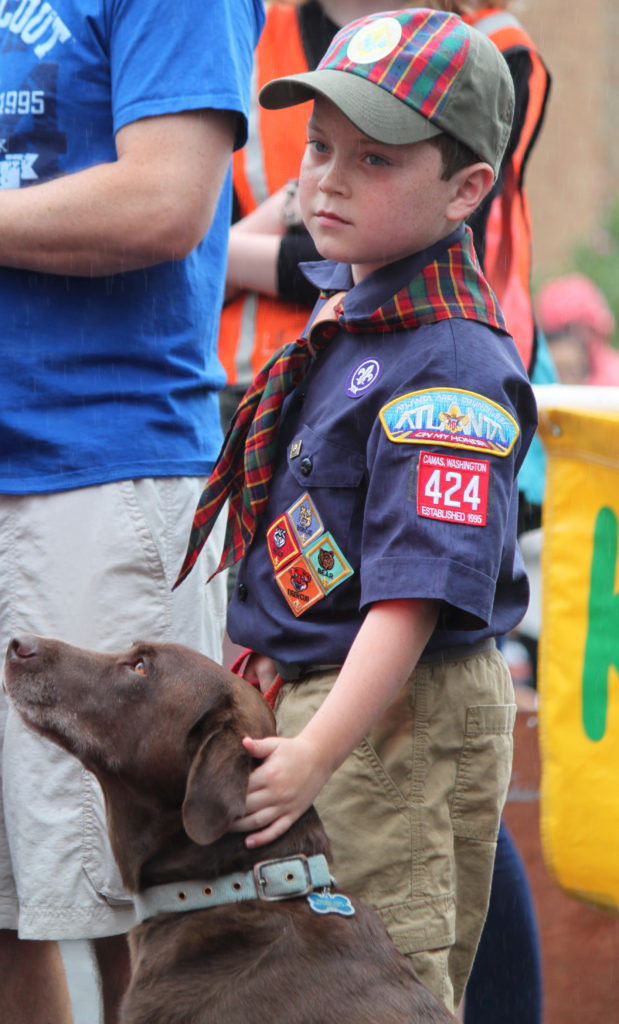 Members of Camas Cub Scout Pack 424 including Brennan Richardson (pictured) participated in the Camas Days Kids' Parade on Friday. The rainy drizzle didn't dampen the spirits of those who took part in the annual march down Northeast Fourth Avenue.