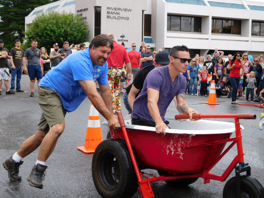 Team Navidi members navigate around the cones during the bathtub races at Camas Days. They lost to iQ Credit Union in a preliminary heat.