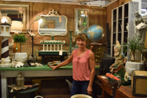 Michelle Robinson stands within her vendor space in Camas Antiques. Robinson has been selling vintage and antique pieces for 10 years. She got into the antiques business after realizing she simply had too much at home, and decided to start selling it. 