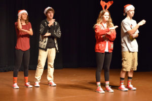 Members of  Music in Motion, an American Sign Language show choir, practice for a holiday performance last year. The group is hosting a fundraiser Thursday for a trip where they will perform at Disneyland. Pictured are Abby Young, Matt Hickey Ashley Cayton and Jake Klackner, performing a song called "I Love Christmas." (Contributed photo)