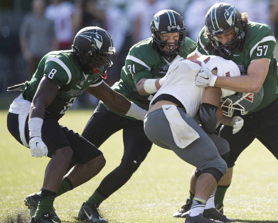 John Norcross (57) and two other Vikings bring down the ball handler from Western Oregon University Sept. 26, 2015, at Providence Park in Portland. Norcross, a 2013 Camas High School graduate, played in all 12 games for PSU, made 28 tackles and finished with 3.5 tackles for loss. (Photo courtesy of Troy Wayrynen)