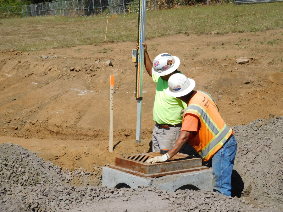 Workers from PHI Construction Inc., set a catch basin at the new transportation facility site behind the Washougal School District office at Evergreen Way. 