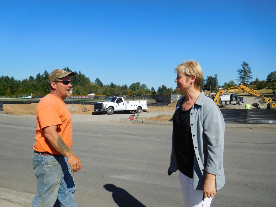 Heidi Rosenberg, Capital Programs director for the Camas School District, chats with an employee of Green Construction. The company is constructing a 191-space lot to relieve some of the parking headaches at the school. It is one of several projects happening in the district. "I am excited to be getting started on so many projects," she said. "The bond just passed in February, and we've already got projects started."