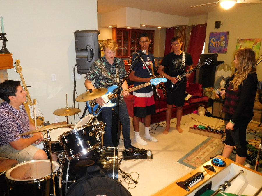From left, Soroush Badiei, Hayden Kane, Gabe Mukobi, Lyne and  Higgins rehearse for an upcoming show in the family room of Badiei's parents' home.