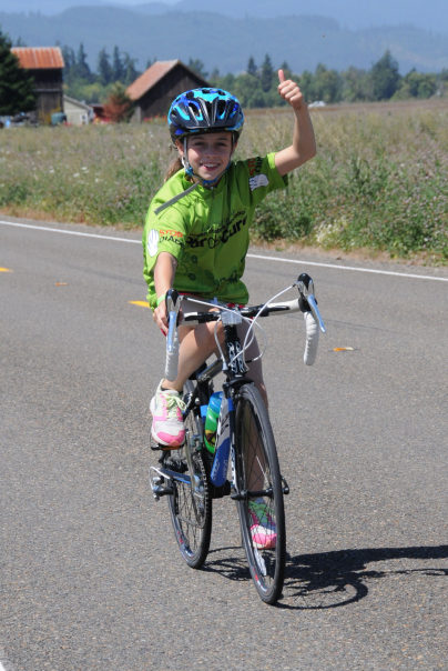 Jamie, 10, gives the thumbs up during a 29 mile bike ride. She rides in honor of her sister, Paige. (Contributed photo)
