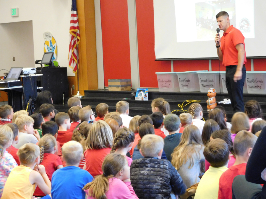 Aaron Parman, principal at Helen Baller Elementary, welcomes students back to school at an assembly Friday. 