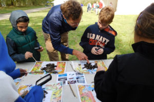 Peter DuBois, an environmental outreach specialist with Clark County Public Health, helps students spot worms in compost.