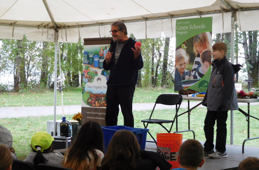 Storyteller Will Hornyak entertains students with a tale of worms and the importance of recycling. He used volunteers from the audience to keep them engaged.