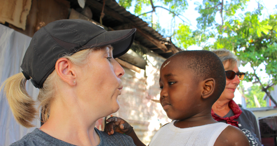 Jen Goheen interacts with one of the Haitian children during her trip there last month. (Photo by Carola Strolger)