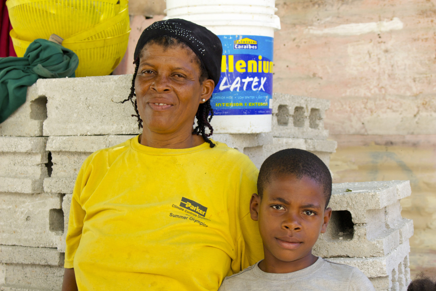 Chantel is a widow with four children ages 11 to 18. Her youngest, Ralph, worked alongside his mom to help build a new home, paid for by Forward Edge. The family contributed sweat equity to help build it. (Photo by Carola Strolger)