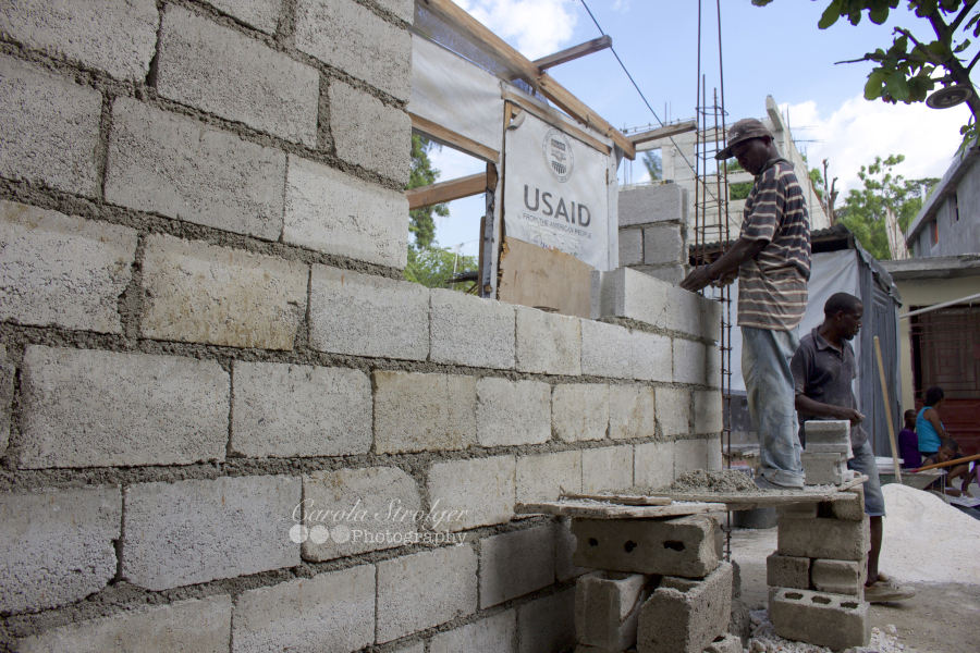 Neighborhood residents help the team from Forward Edge construct a home for a widow and her children. (Photo by Carola Strolger)