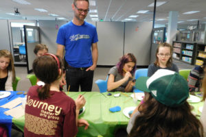 Principal Aaron Smith chats with seventh-graders working on a "kindness rocks," art project at the new Project Based Learning Middle School in Camas.