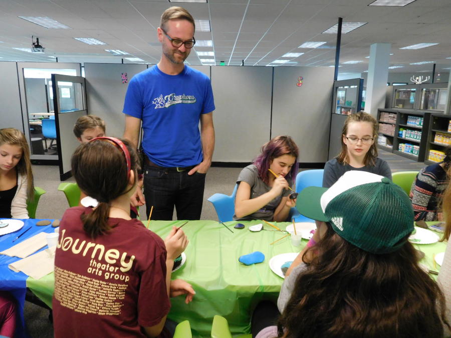 Principal Aaron Smith chats with seventh-graders working on a "kindness rocks," art project at the new Project Based Learning Middle School in Camas.