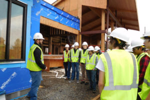 Josh Clark, project engineer for the new Excelsior High School, chats with visiting students from woodworking classes at Washougal High School. This was the first of several visits the students will take to see the construction process in action this semester. 