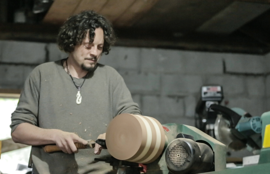 Blind woodworker John Furniss works on his latest project using a wood lathe, which is his favorite tool for creating different pieces.