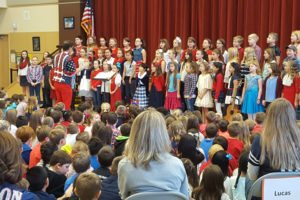 Students at Woodburn Elementary School honor those who served in the military and who are current service members at its Veterans' Day Assembly Thursday.