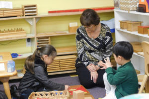 Donna Hargrave, school administrator, works with students at Camas Montessori School recently. After an almost three year process, the school has moved into its new location at Northeast Everett Street and 23rd Avenue, and is hosting an open house for the community on Dec. 3.