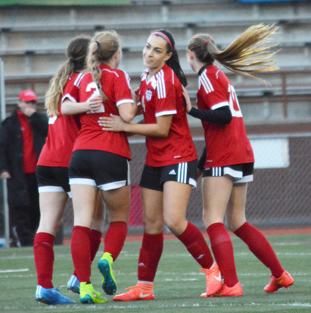 Maddie Kemp (center) celebrates with Perri Belzer, Morgan Winston (left) and Jazzlynn Paulson after scoring the first goal of the state championship game. 