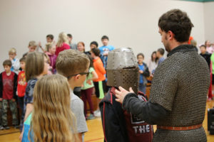 A student tries on a traditional knight's helmet during an assembly at Cape Horn-Skye Elementary . (Contributed photo)