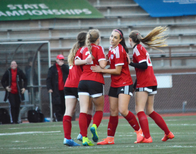 Maddie Kemp (center) celebrates with Perri Belzer, Morgan Winston and Jazzlyn Paulson after scoring the firsl goal of the state championship game for Camas.