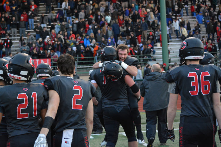 Vinny Gennaro jumps into the arms of Caleb Eldred after the Camas High School football team beat Sumner 45-21 in the semifinals of the 4A state tournament Nov. 26, at McKenzie Stadium in Vancouver.