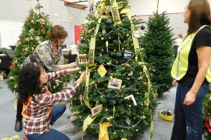 Washougal School District office staff members decorate a construction themed tree for the annual Festival of Trees last weekend. Proceeds from the event benefit Washougal schools.