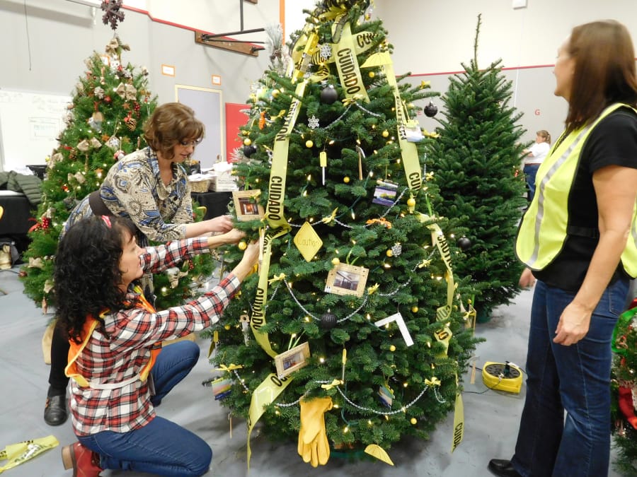 Washougal School District office staff members decorate a construction themed tree for the annual Festival of Trees last weekend. Proceeds from the event benefit Washougal schools.