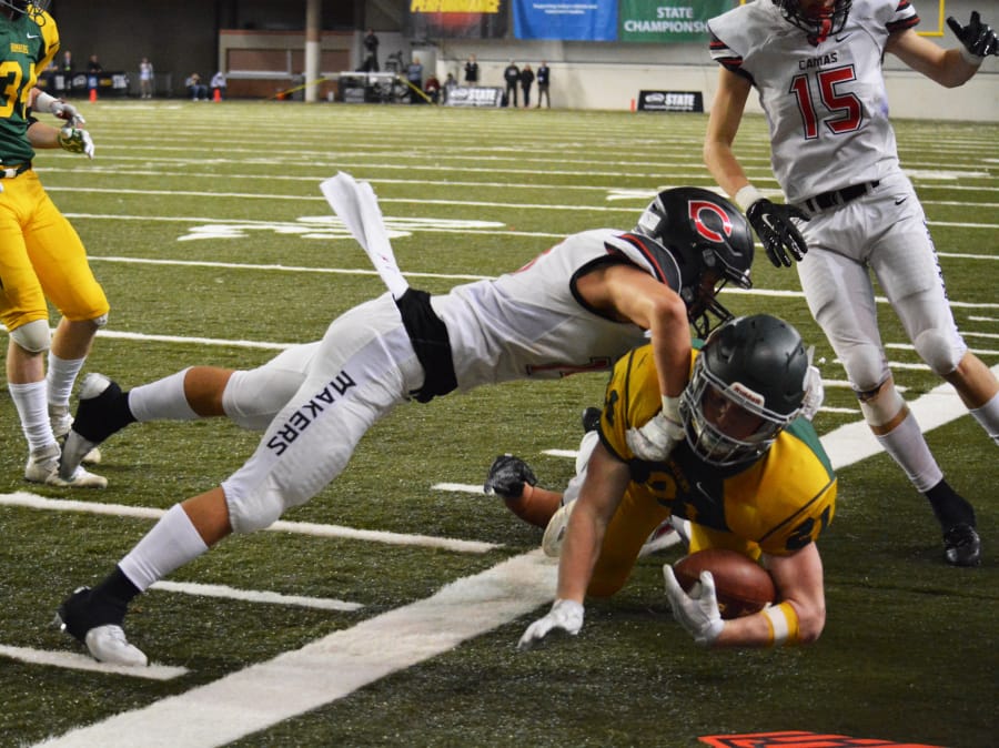 Sedric Ruiter shoves a Richland Bomber out of bounds on fourth down and inches. This stop gave the Papermakers an opportunity to put the game away in the fourth quarter.