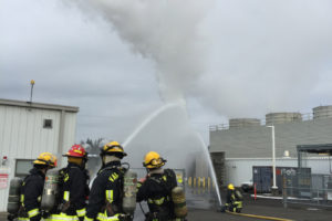 Camas-Washougal Fire Department crews douse a 3,000 gallon hydrogen tank with water, to keep it cool after a fire started nearby on Saturday. The tank eventually vented, releasing a large cloud of hydrogen vapor that did not ignite.