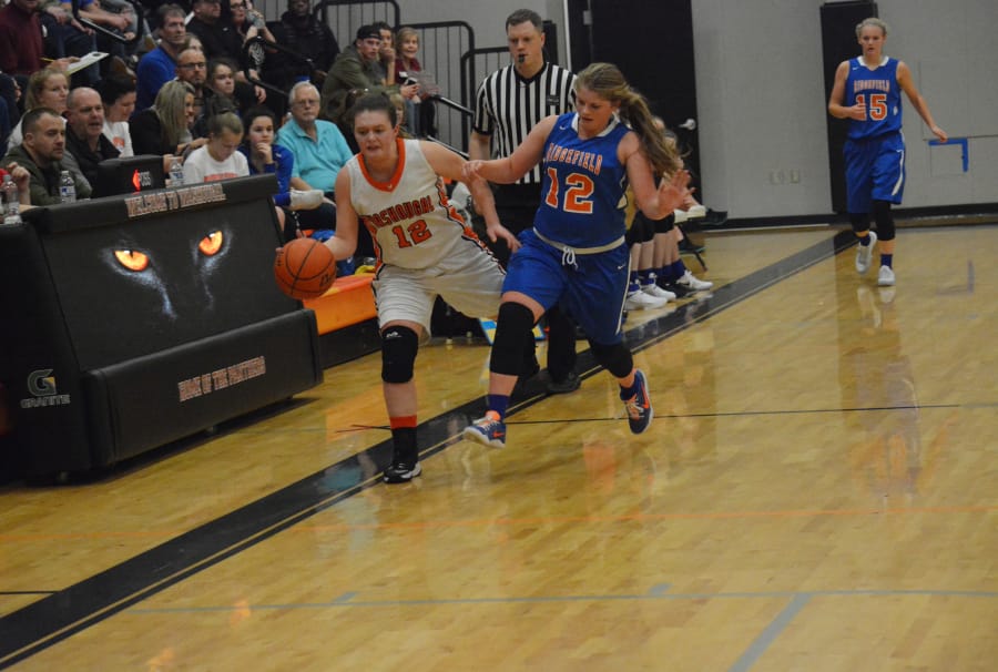 Lindsey Thomas steals the ball and tries to keep it in bounds for Washougal.