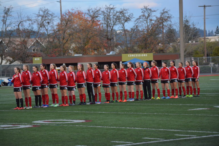 The Camas High School girls soccer team stands during the National Anthem before playing West Valley, Yakima, in the 4A state championship game.