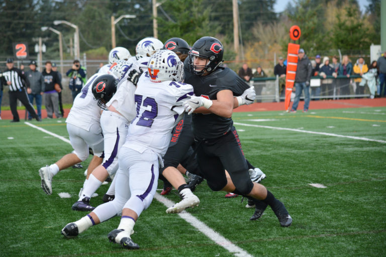 Dylan Ingram and the Camas offensive linemen smash into Sumner.