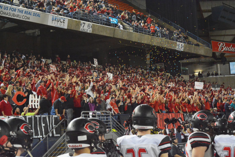 Camas fans chant "I believe that we will win" during the opening ceremonies of the state championship football game at the Tacoma Dome.