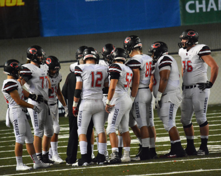 The Camas offensive players huddle up before going back out on the field for an important third down play.