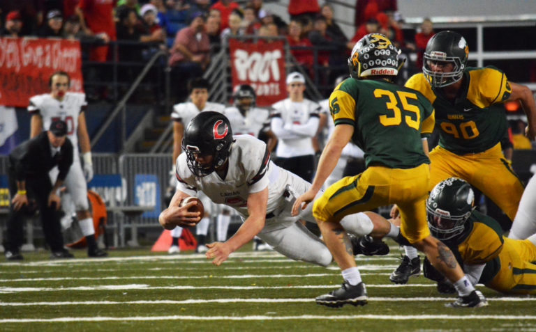 Camas quarterback Jack Colletto dives for a first down.
