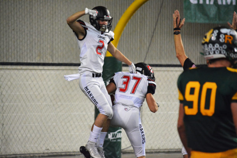 Ryan Rushall jumps on Will Schultz after Schultz scored a touchdown to help Camas regain the lead in the third quarter.