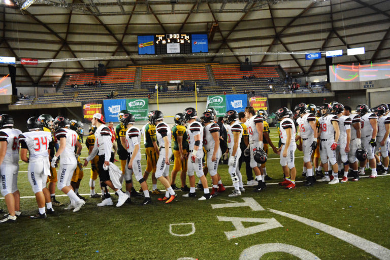 The Camas and Richland football players slap hands after playing an exciting state championship game at the Tacoma Dome.